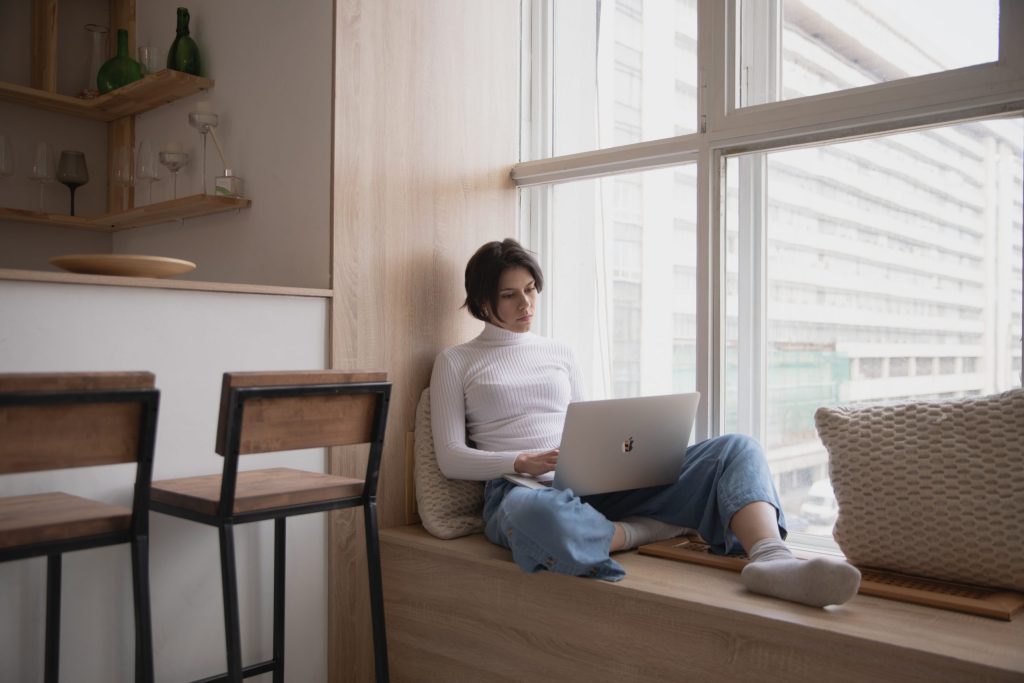 A woman uses a laptop.