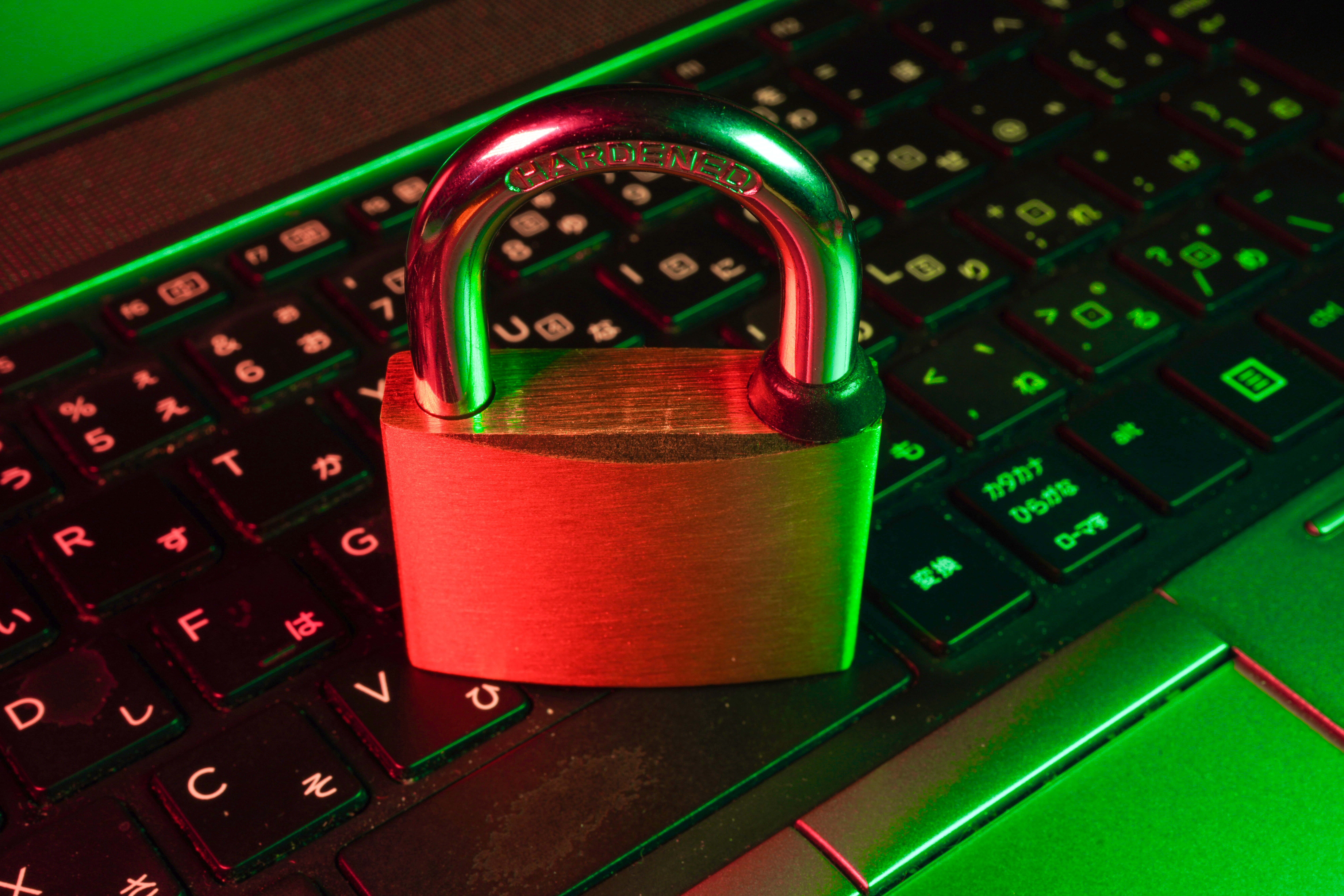 A padlock is shown on top of a computer keyboard.