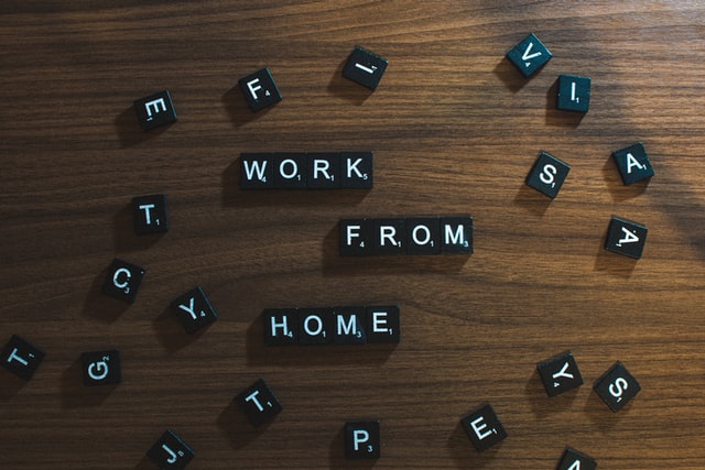 Words “Work from home” spelled using Scrabble tiles.