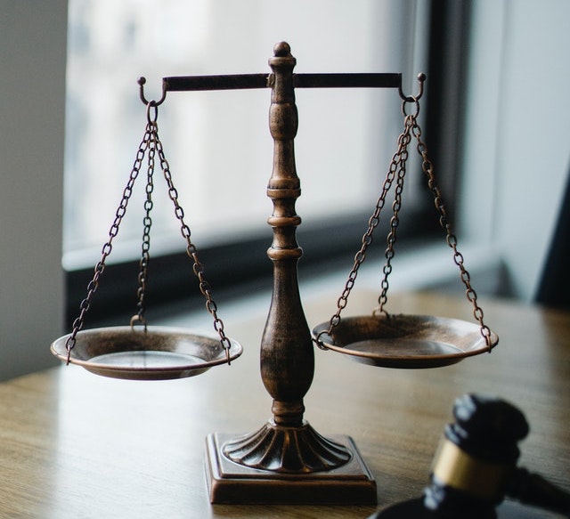 Scales of justice next to a gavel.