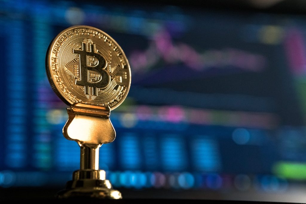 Bitcoin placed in front of a monitor