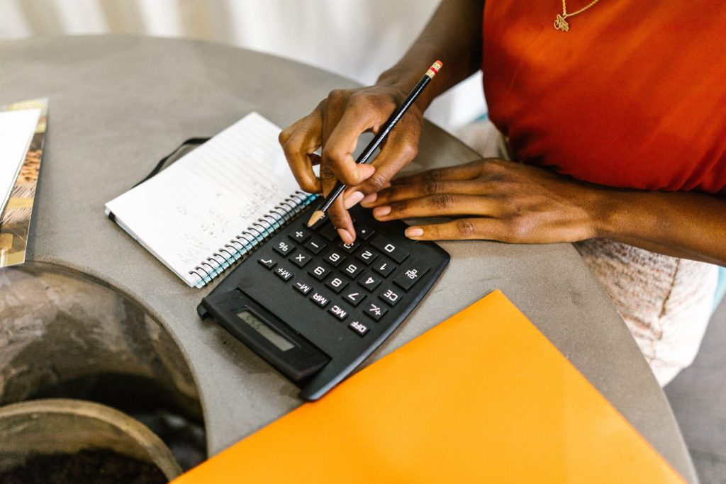 Close-up of a woman using calculator