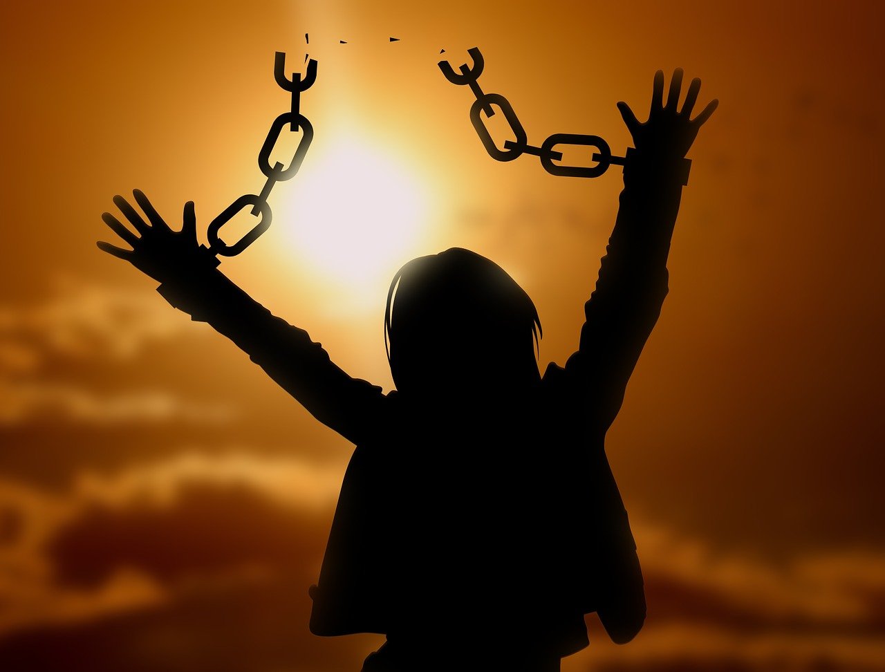 A person breaking free of their chains.
