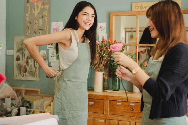 Two female florists having a conversation.