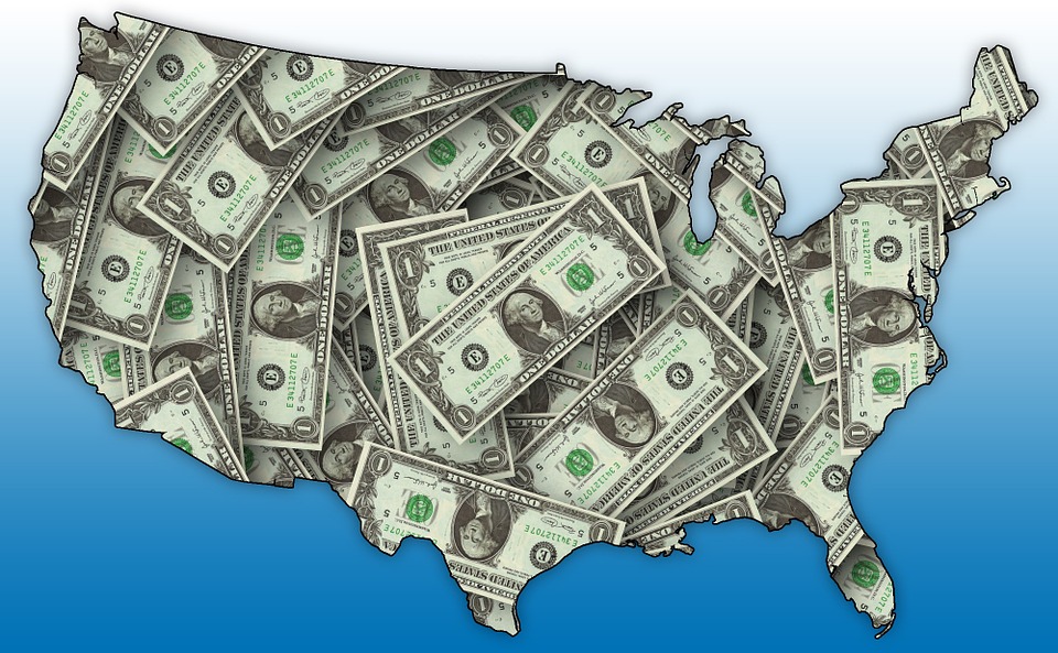 A map of the U.S. outlined in dollar bills.