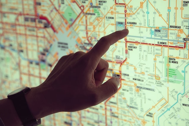 Close-up of a hand pointing a map.