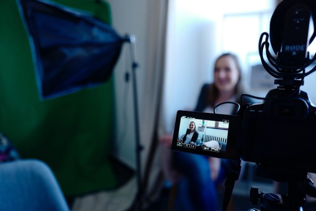 A woman is recorded while giving a video testimonial.