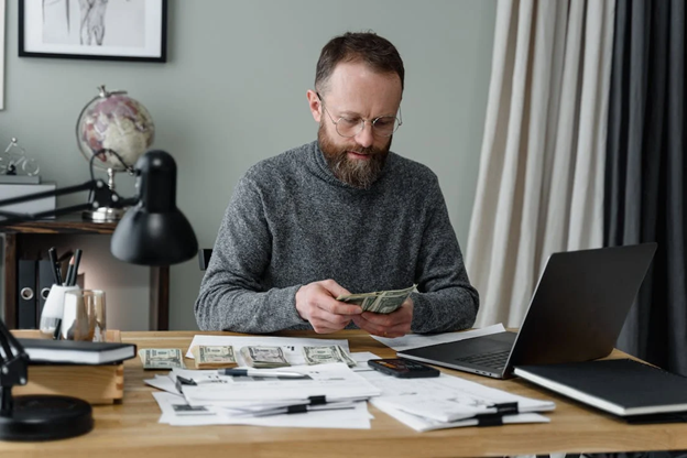 Businessman counting his cash.