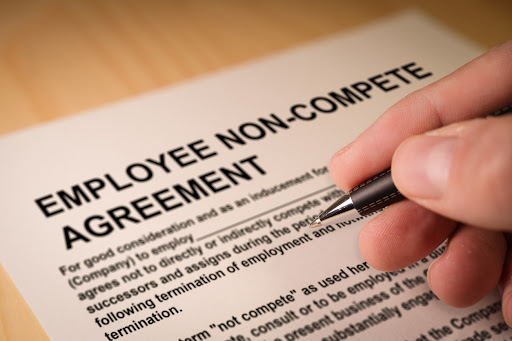 Employee signing a noncompete agreement.