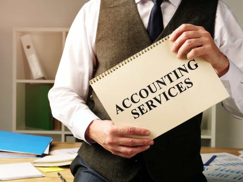 Accounting services sign in the hands of accountant
