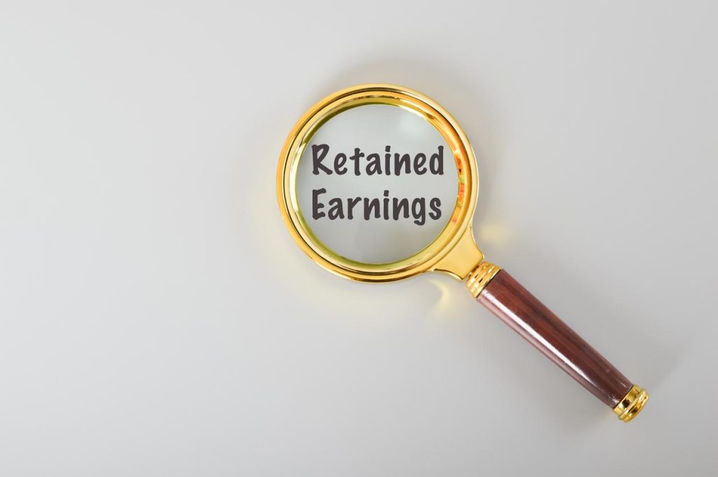 Text “retained earnings” inside magnifying glass