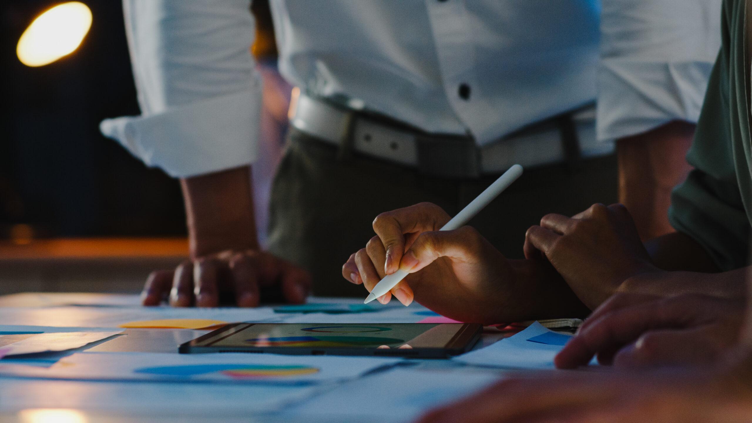 hand-holding-stylus-at-office-desk-reviewing-beneficial-ownership-information-filing-requirements