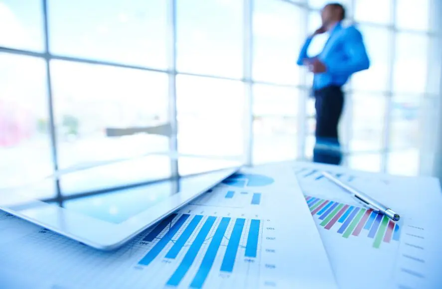 Businessman reviewing financial charts - Escalon Voluntary Disclosure Agreement VDA services for non-compliant businesses