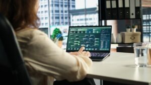 Founder reviewing monthly burn rate spreadsheet with cash runway projections on laptop screen